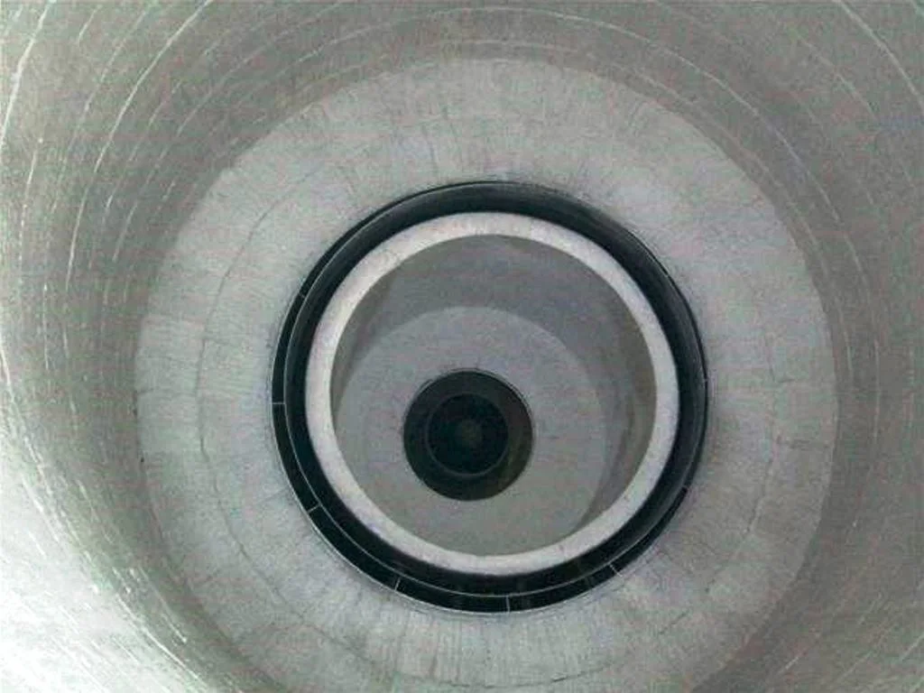 An overhead image looking down on a refractory burning being relined in a dryer.